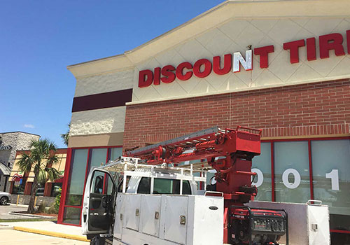 city signs repairing discount tire storefront signage